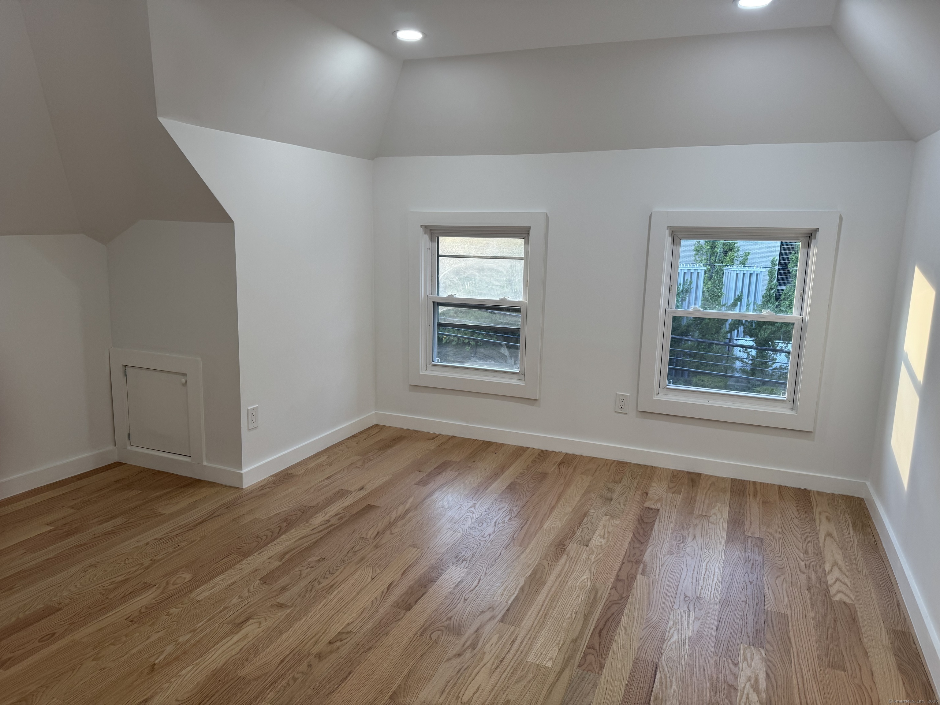 263 Hawley Avenue Bridgeport, CT 06606 - Photo 14 of 19 an empty room with wooden floor and windows