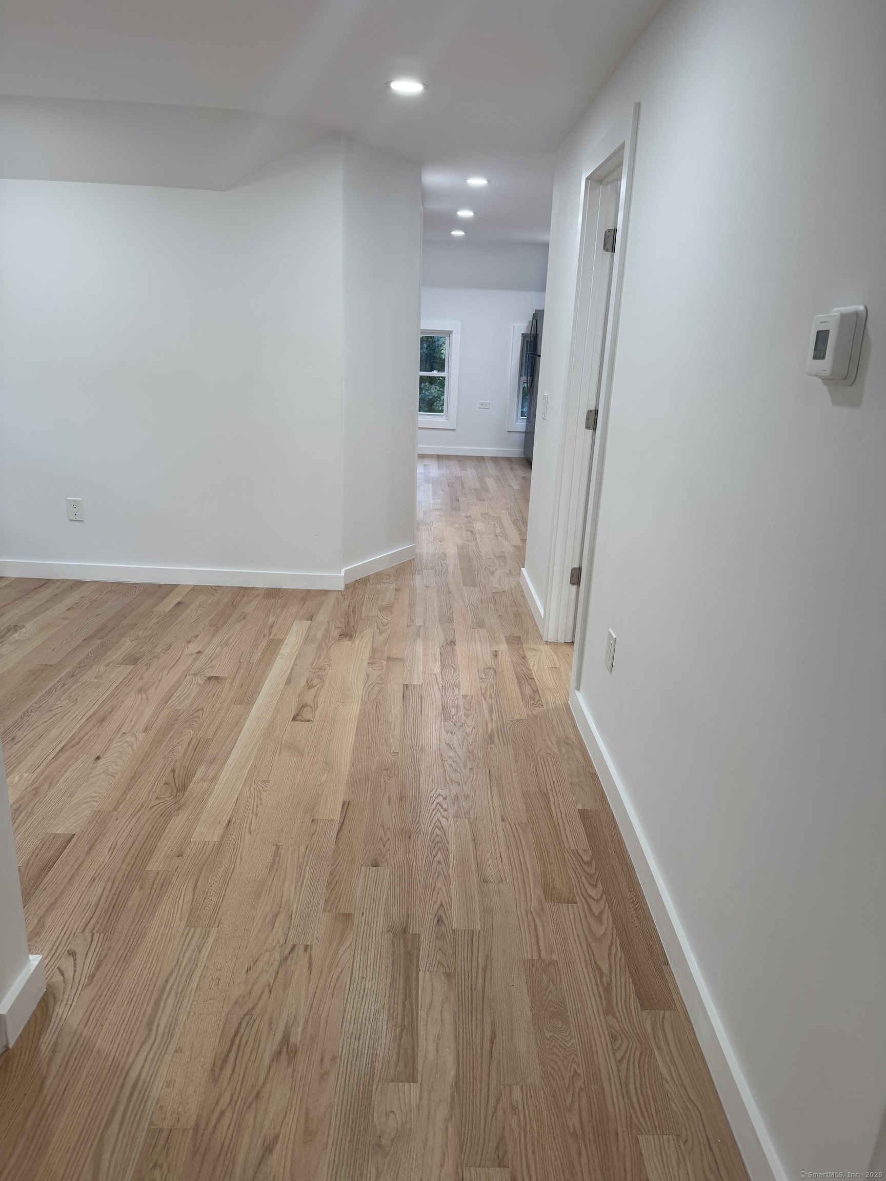 263 Hawley Avenue Bridgeport, CT 06606 - Photo 6 of 19 a view of a hallway with wooden floor