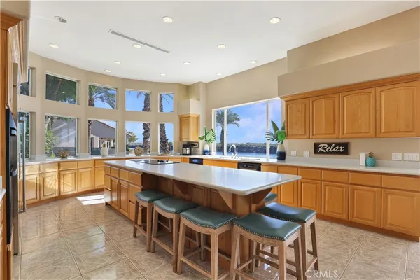 a kitchen with stainless steel appliances granite countertop a sink wooden cabinets and a granite counter top