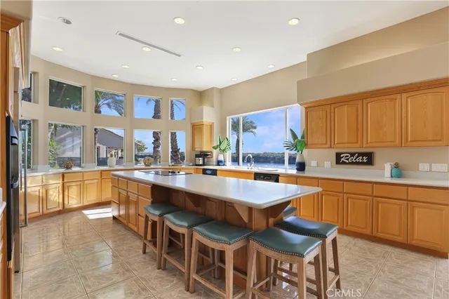 a kitchen with stainless steel appliances granite countertop a sink wooden cabinets and a granite counter top
