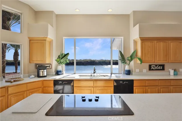 a kitchen with stainless steel appliances granite countertop a sink and a refrigerator
