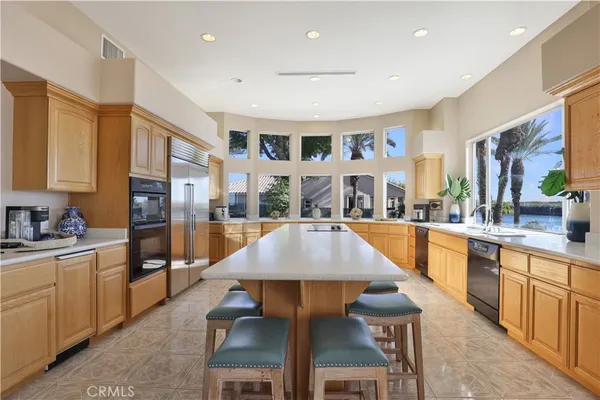 a large kitchen with a table and chairs