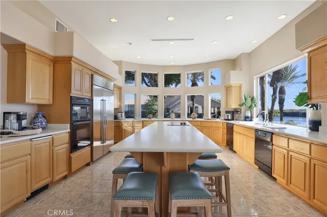 a large kitchen with a table and chairs