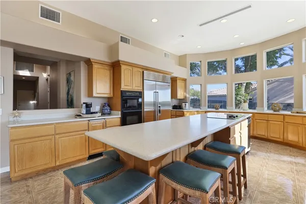 a large kitchen with stainless steel appliances lots of counter space and a sink