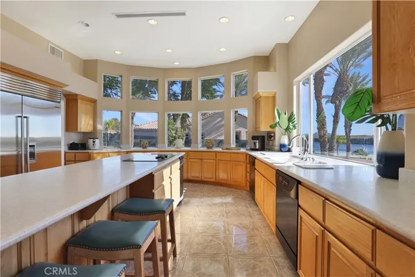 a kitchen with stainless steel appliances granite countertop a sink and a stove