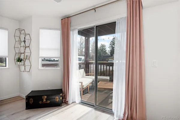 a living room with a large window and a view of bedroom