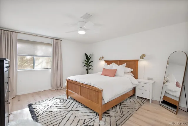 a bedroom with a large bed and a window