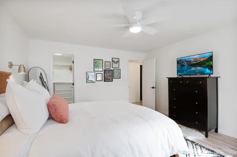 a bedroom with a bed and a painting on the wall