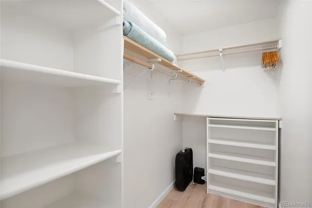 a view of walk in closet with empty racks