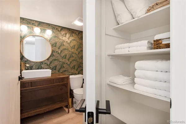 a bathroom with a sink mirror vanity and toilet