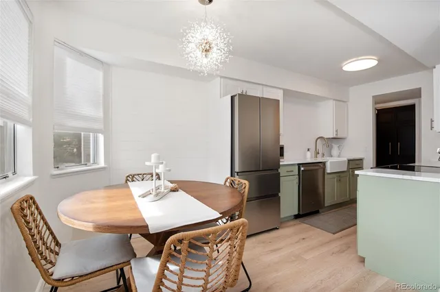 a view of a dining room with furniture and chandelier