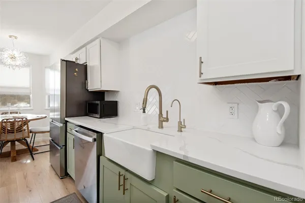 a kitchen with a sink a stove and cabinets