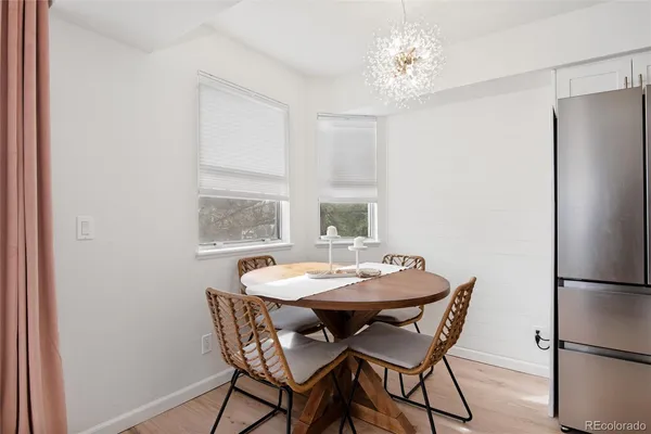 a view of a dining room with furniture window and wooden floor