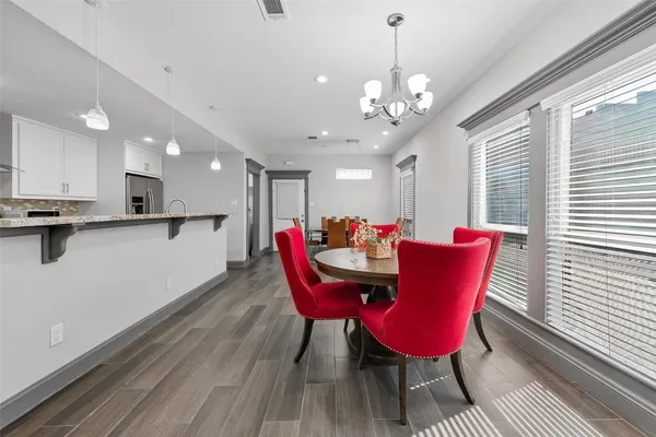 a view of a dining room with furniture and wooden floor