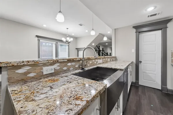 a kitchen with a stove and a sink