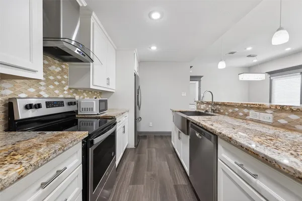 a kitchen with a stove and a sink