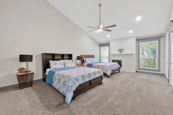 a spacious bedroom with a bed and window