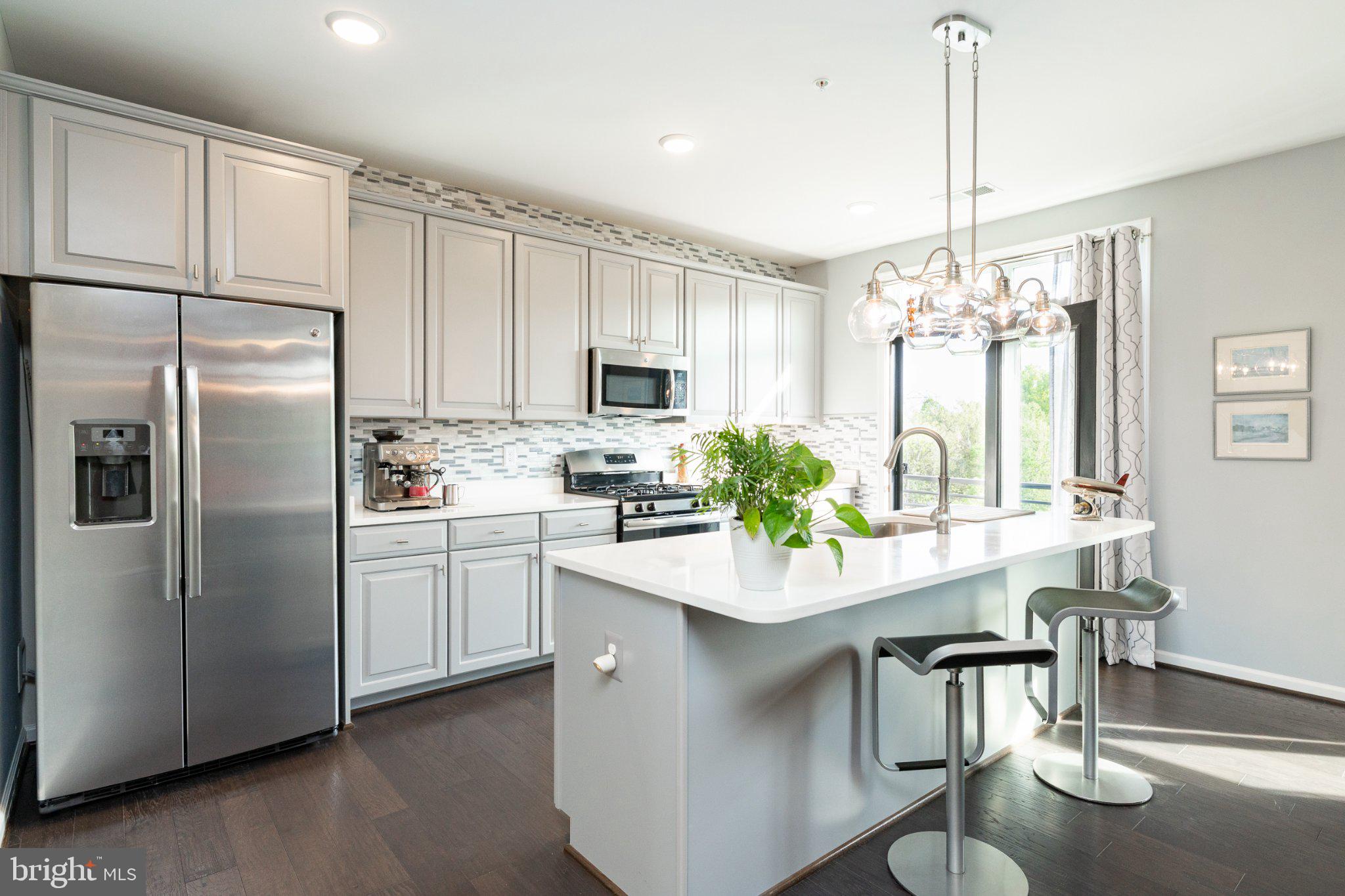 1414 Ribbon Limestone Terrace Southeast, Unit E204 Leesburg, VA 20175 - Photo 1 of 49 Modern kitchen with sleek finishes.