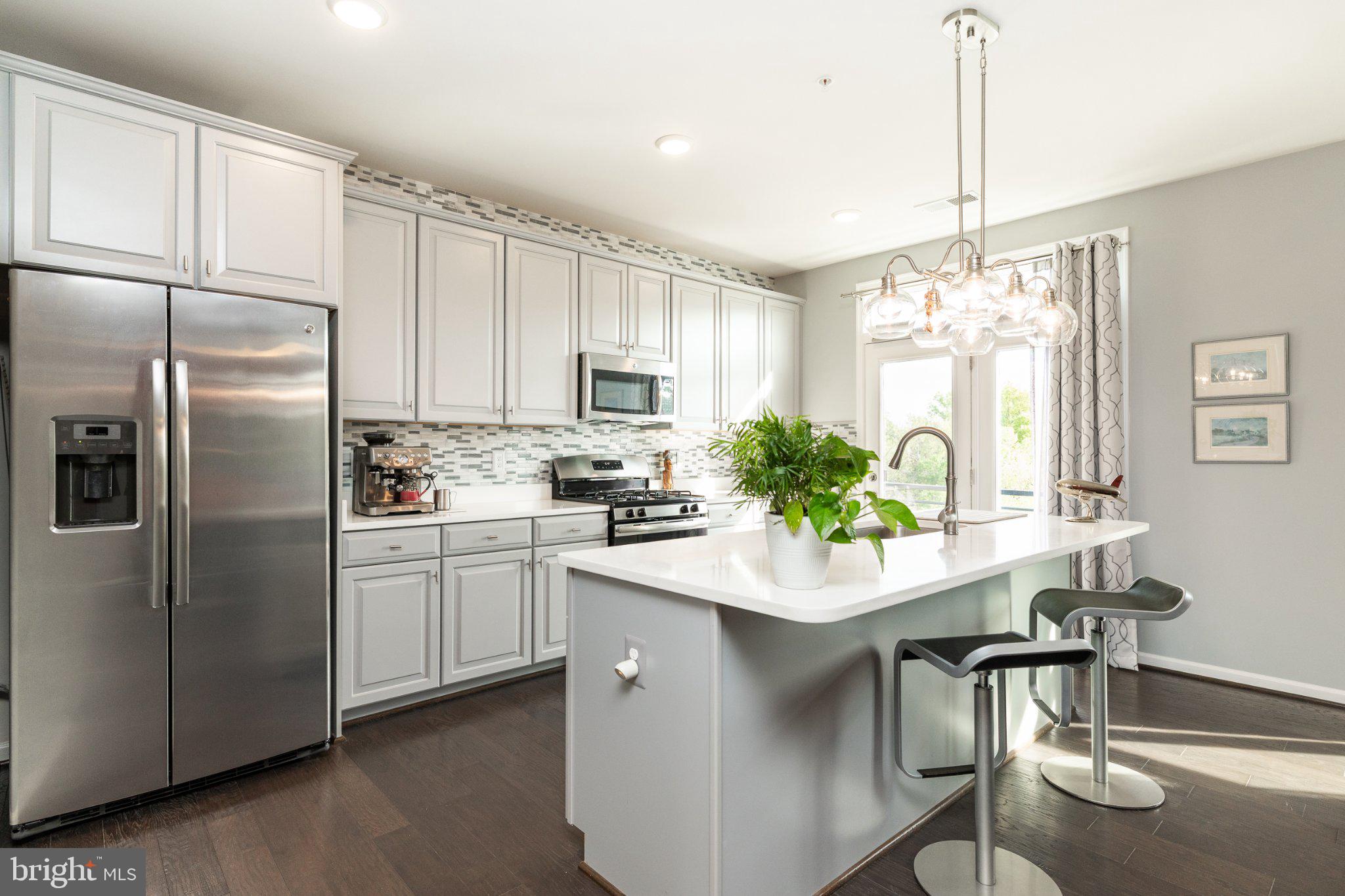 1414 Ribbon Limestone Terrace Southeast, Unit E204 Leesburg, VA 20175 - Photo 2 of 49 Modern kitchen with sleek finishes.