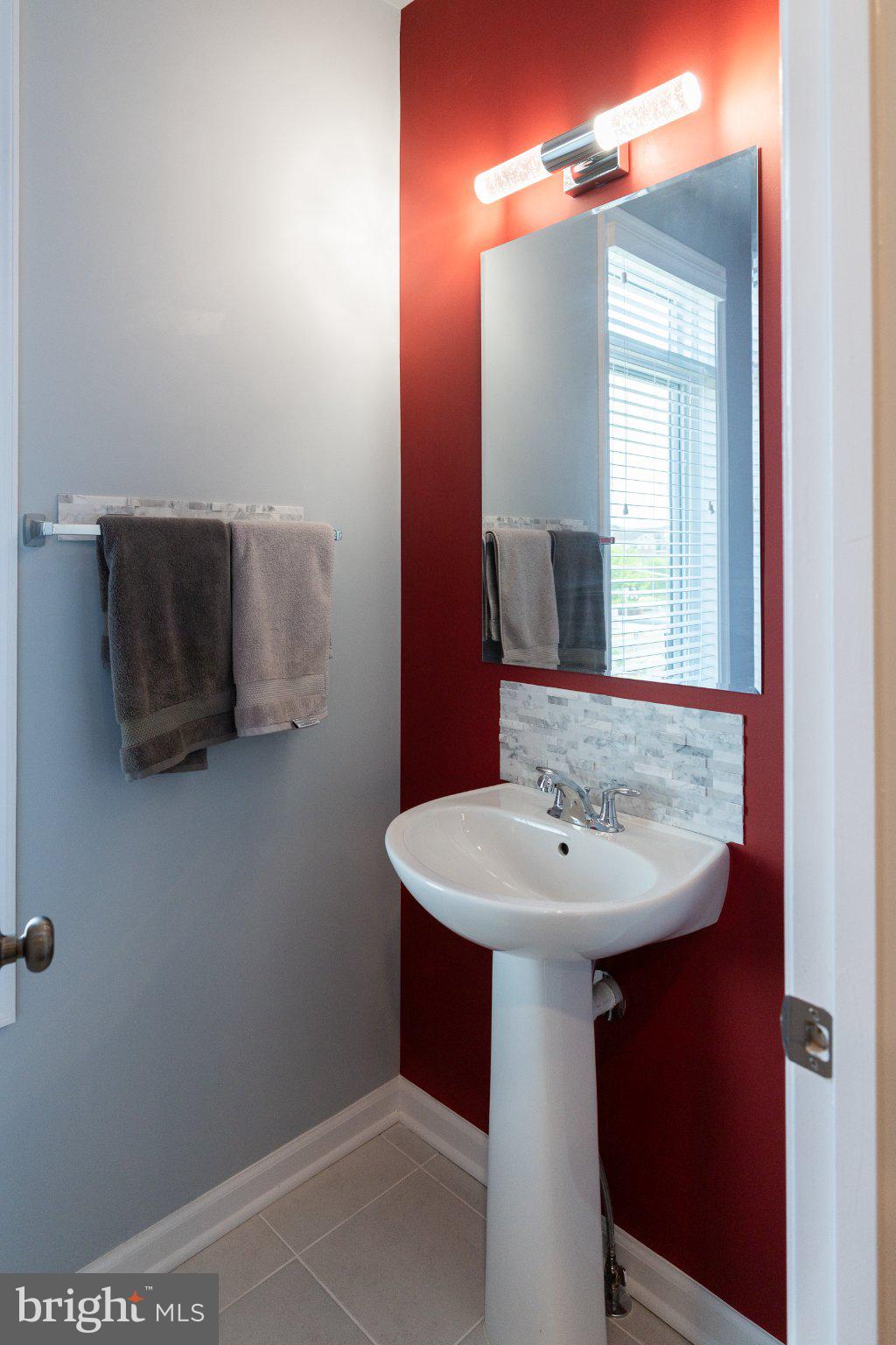 1414 Ribbon Limestone Terrace Southeast, Unit E204 Leesburg, VA 20175 - Photo 22 of 49 Chic half-bath with bold accents.