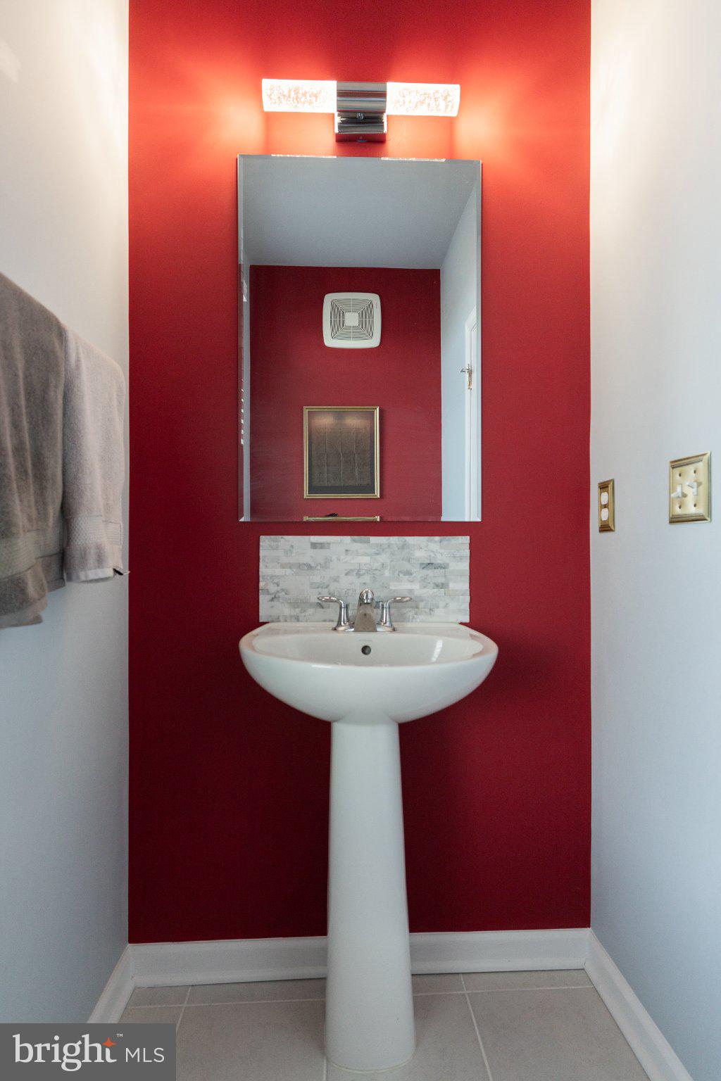 1414 Ribbon Limestone Terrace Southeast, Unit E204 Leesburg, VA 20175 - Photo 23 of 49 Vibrant red accent in a chic bathroom.
