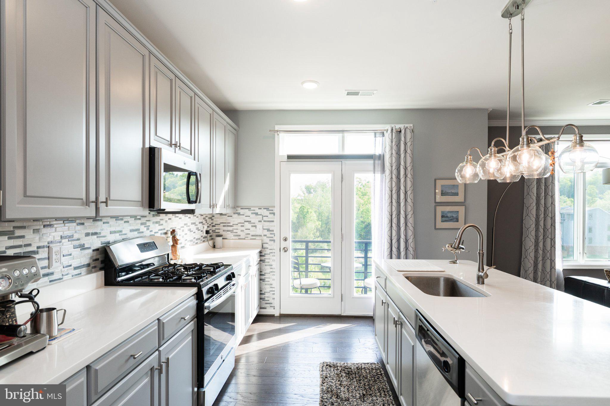 1414 Ribbon Limestone Terrace Southeast, Unit E204 Leesburg, VA 20175 - Photo 3 of 49 Modern kitchen with elegant finishes.