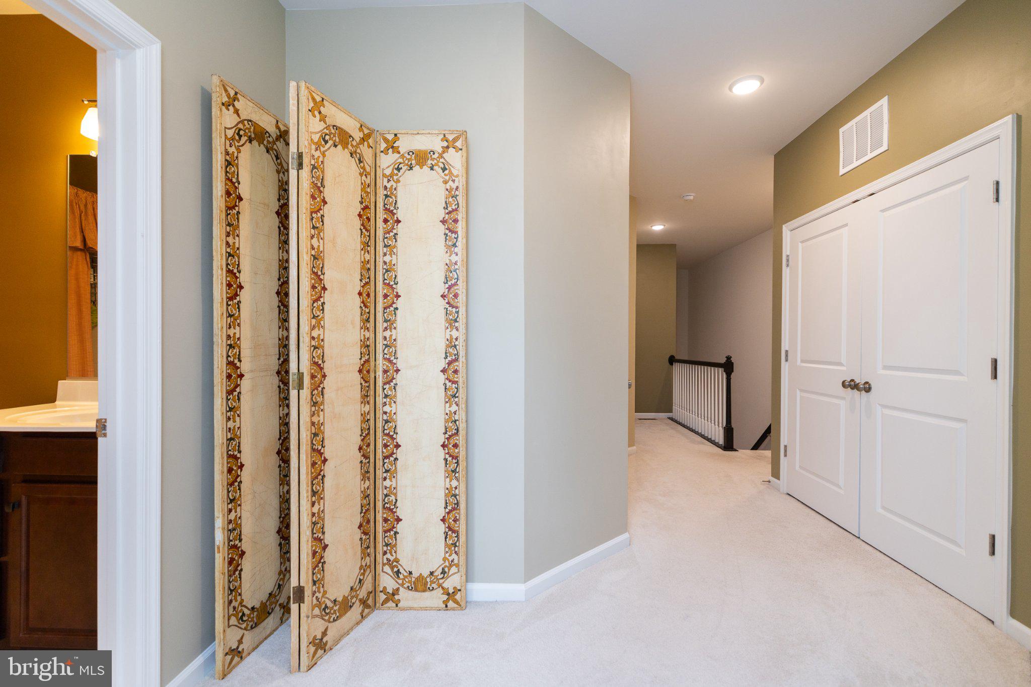 1414 Ribbon Limestone Terrace Southeast, Unit E204 Leesburg, VA 20175 - Photo 37 of 49 Elegant hallway with decorative screen.