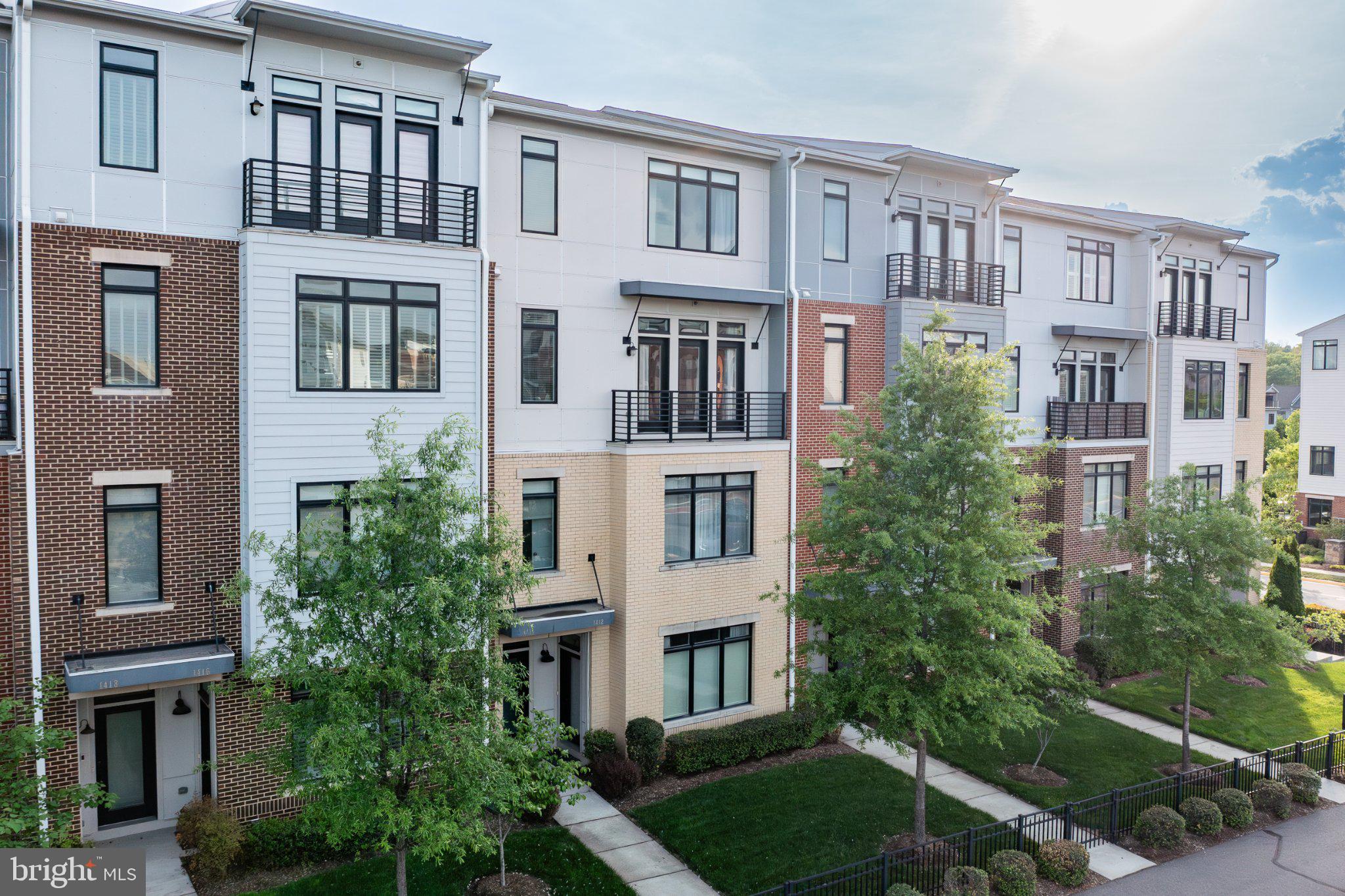 1414 Ribbon Limestone Terrace Southeast, Unit E204 Leesburg, VA 20175 - Photo 44 of 49 Modern townhomes with lush greenery.