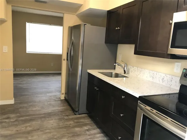 a kitchen with a sink and a refrigerator