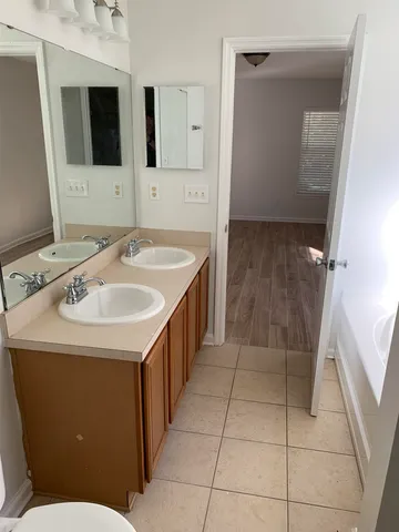 a bathroom with a sink a toilet and a shower