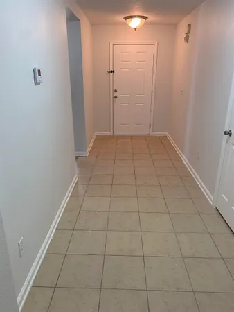 a view of a livingroom with an empty space and a window in a room