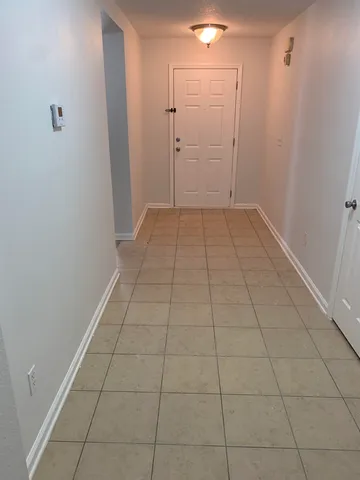 a view of a livingroom with an empty space and a window in a room