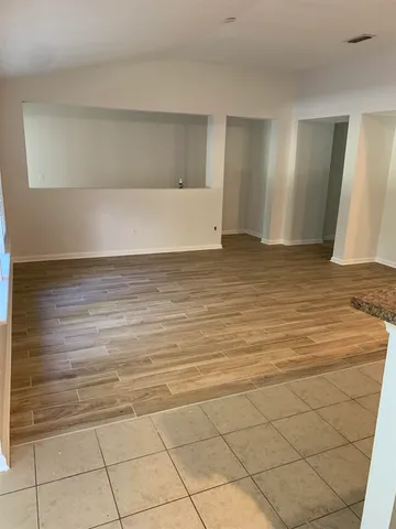 a view of wooden floor and staircase in a room