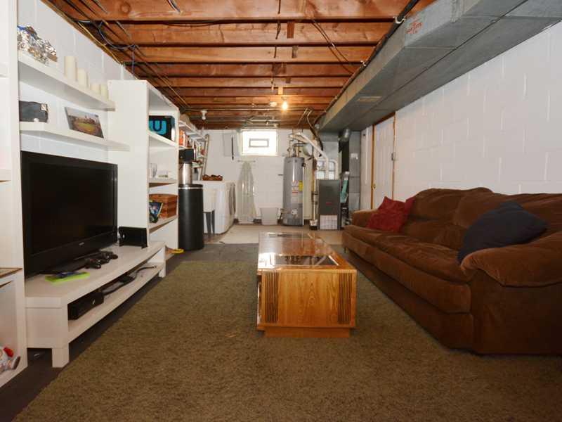1305 Cathell Road Baldwin, PA 15236 - Photo 20 of 23 Basement/Game Room. Opposite angle view of the lower level showing the laundry area, water heater, HVAC system, and the door to the integral garage.