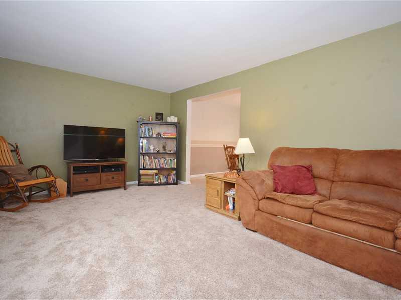 Living Room. The carpeted living room measures a sizable 14 x20. It is located to the left of the front entry. The wide opening at the top center leads to the dining room.