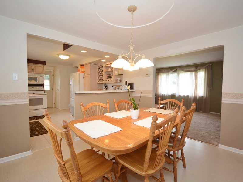 Dining Room. Opposite angle view of the dining room showing the wide opening to the living room, as well as the large window overlooking the front of the property, and the open layout to the kitchen. There is great flow on the main level!