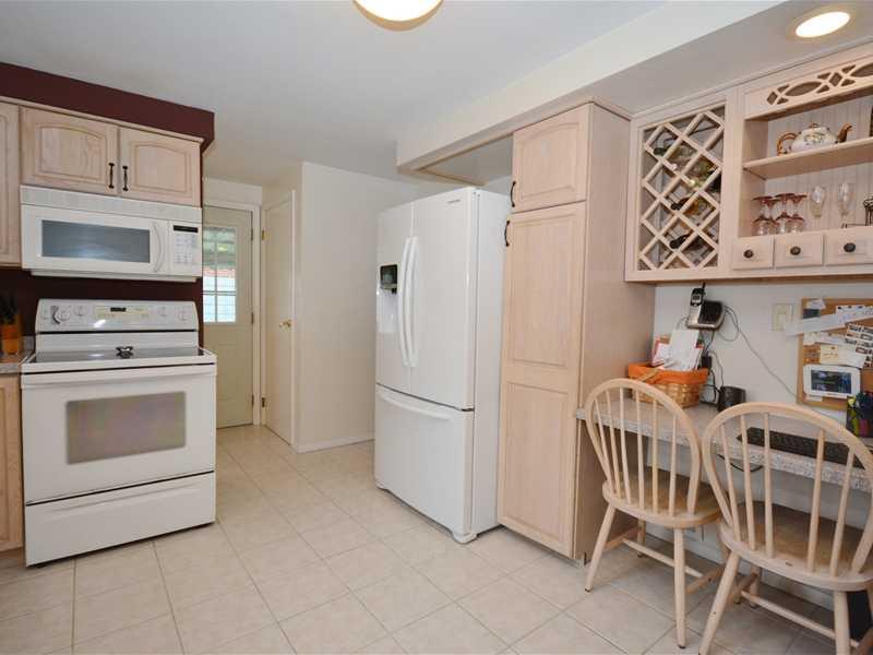 1305 Cathell Road Baldwin, PA 15236 - Photo 9 of 23 Kitchen. There is attractive and practical built-in storage above the kitchen desk. The closed door at the top center opens to the lower level. The powder room is directly across from that door.