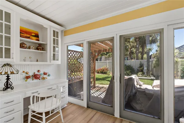 a dining room with furniture and a garden view