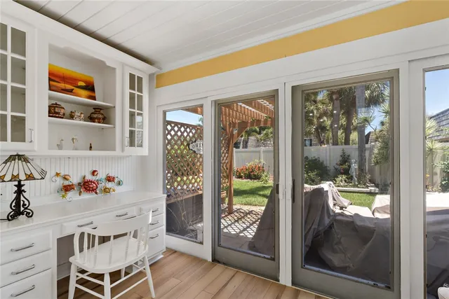 a dining room with furniture and a garden view