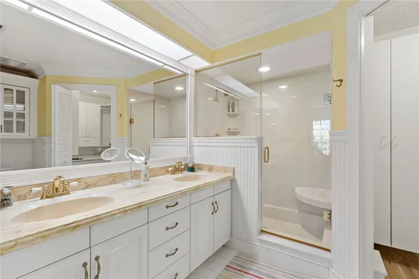 a spacious bathroom with a granite countertop sink a toilet a shower and a mirror