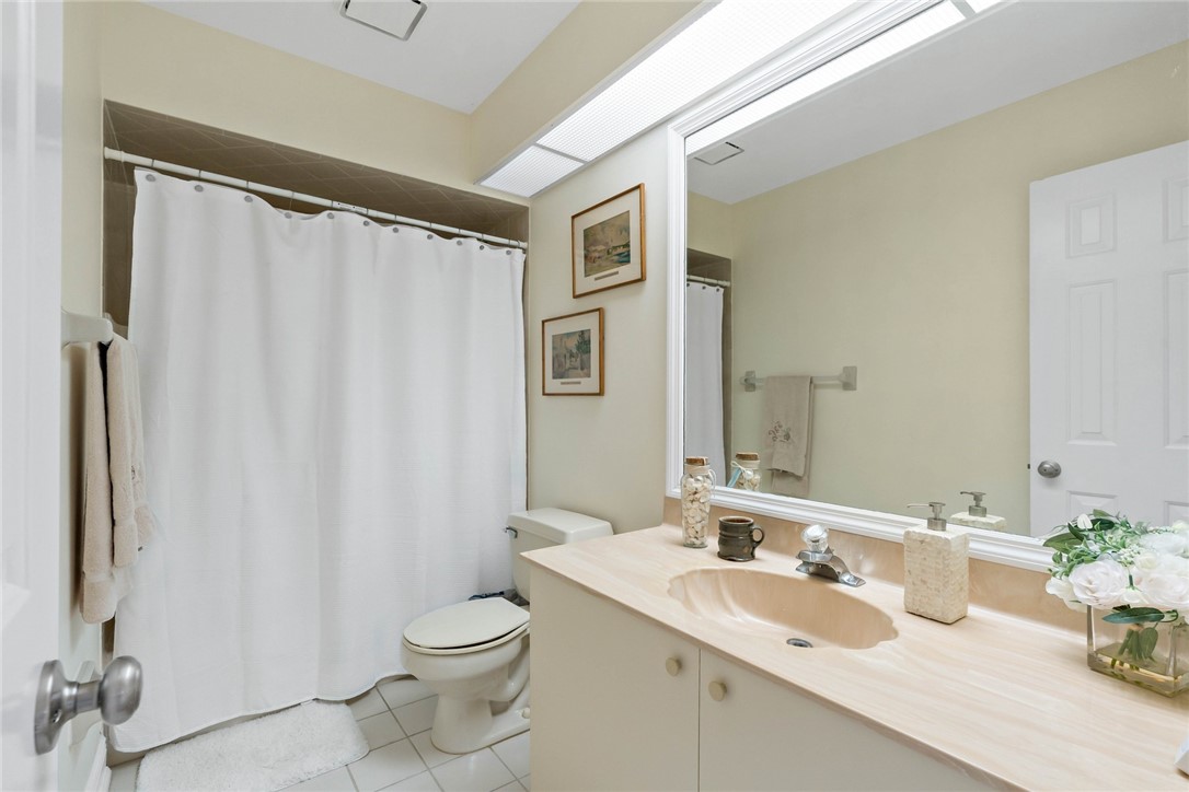 470 9th Place Vero Beach, FL 32960 - Photo 19 of 28 a bathroom with a granite countertop sink toilet and a mirror