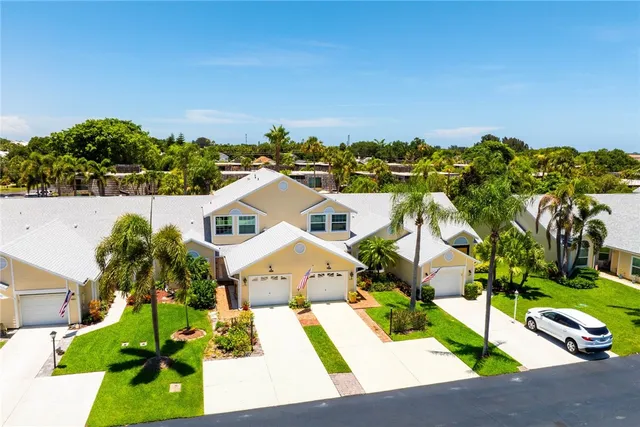 an aerial view of residential houses with outdoor space and street view