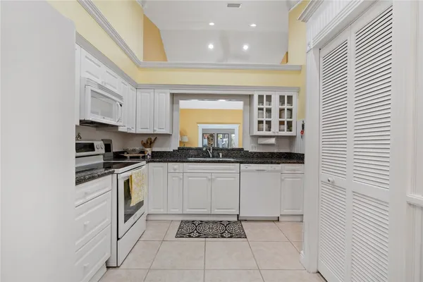 a kitchen with stainless steel appliances granite countertop a sink and cabinets