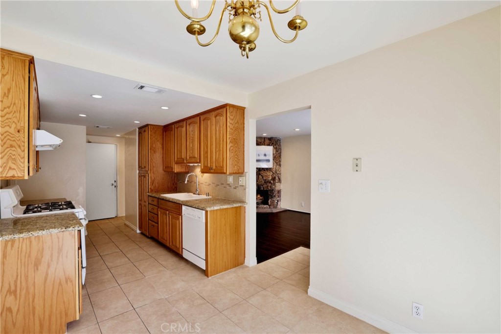 11557 Lower Azusa Road, Unit D El Monte, CA 91732 - Photo 14 of 38 a kitchen with a stove and a refrigerator