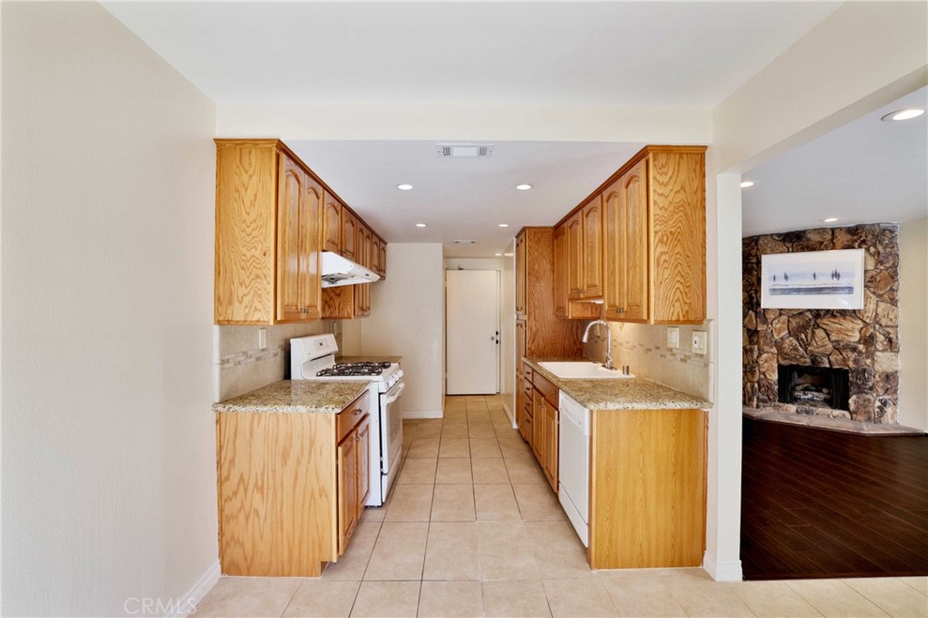 11557 Lower Azusa Road, Unit D El Monte, CA 91732 - Photo 15 of 38 a open kitchen with stainless steel appliances granite countertop a stove and a refrigerator
