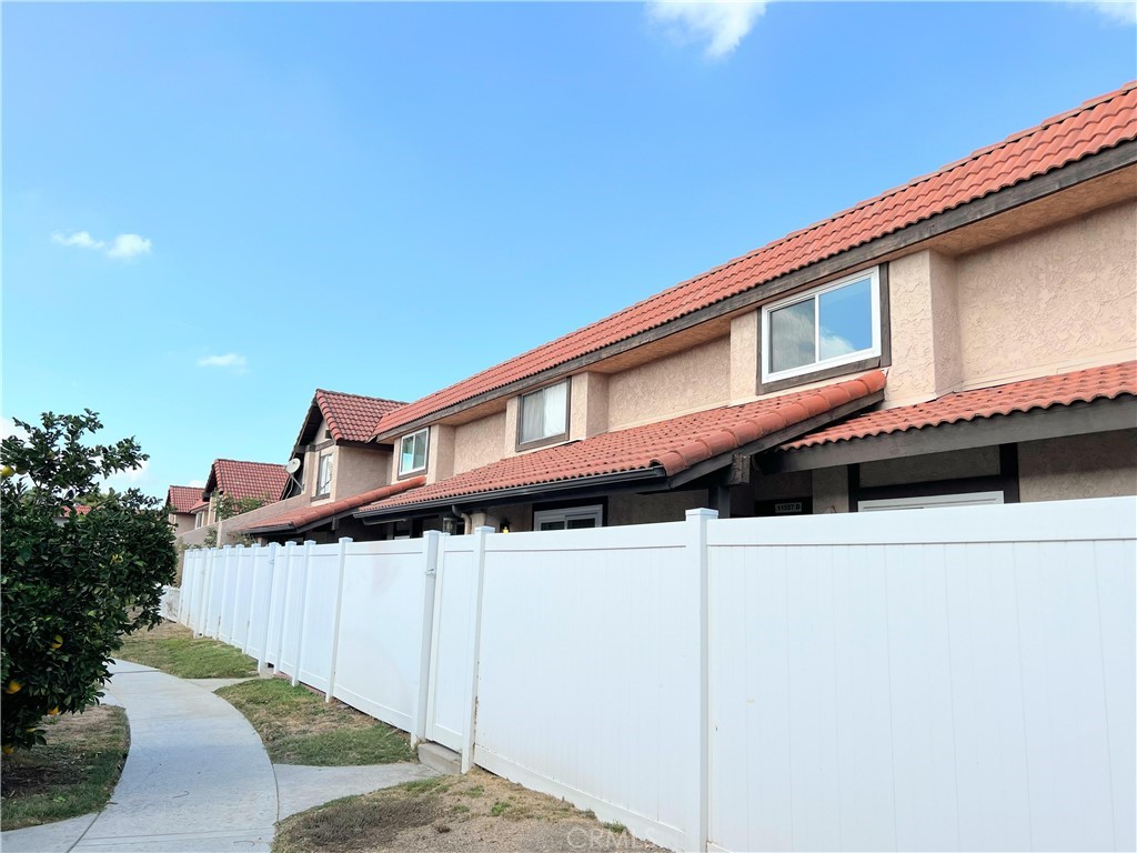 11557 Lower Azusa Road, Unit D El Monte, CA 91732 - Photo 2 of 38 a large building with a large window and potted plants