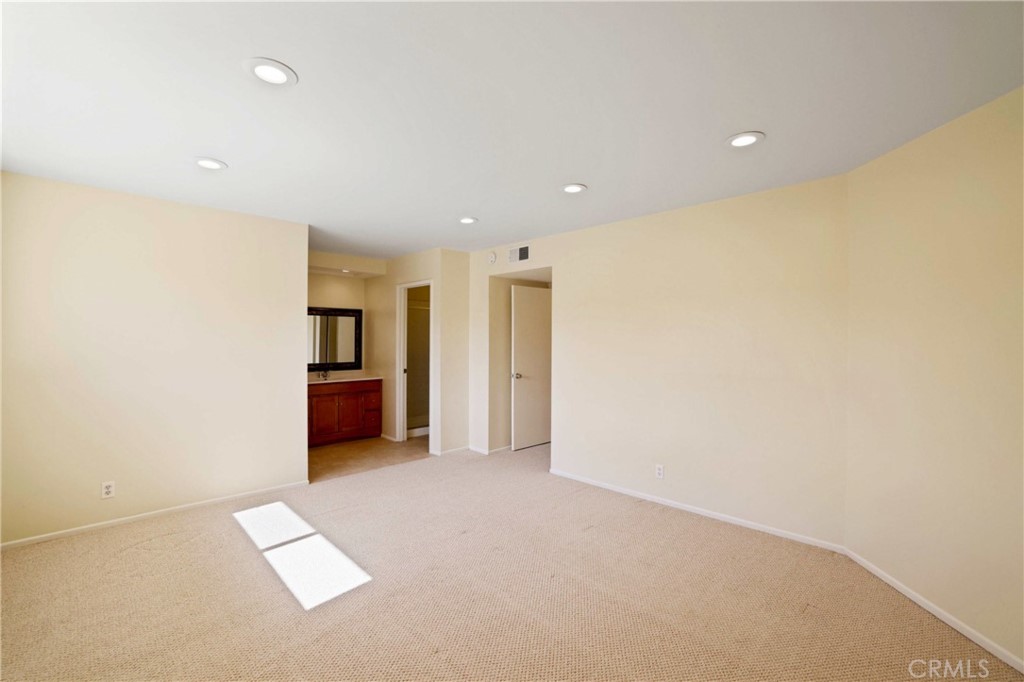 11557 Lower Azusa Road, Unit D El Monte, CA 91732 - Photo 21 of 38 an empty room with kitchen refrigerator and a kitchen