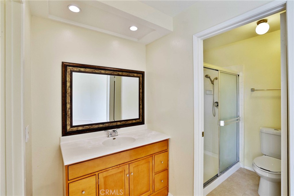 11557 Lower Azusa Road, Unit D El Monte, CA 91732 - Photo 24 of 38 a bathroom with a toilet sink and a mirror