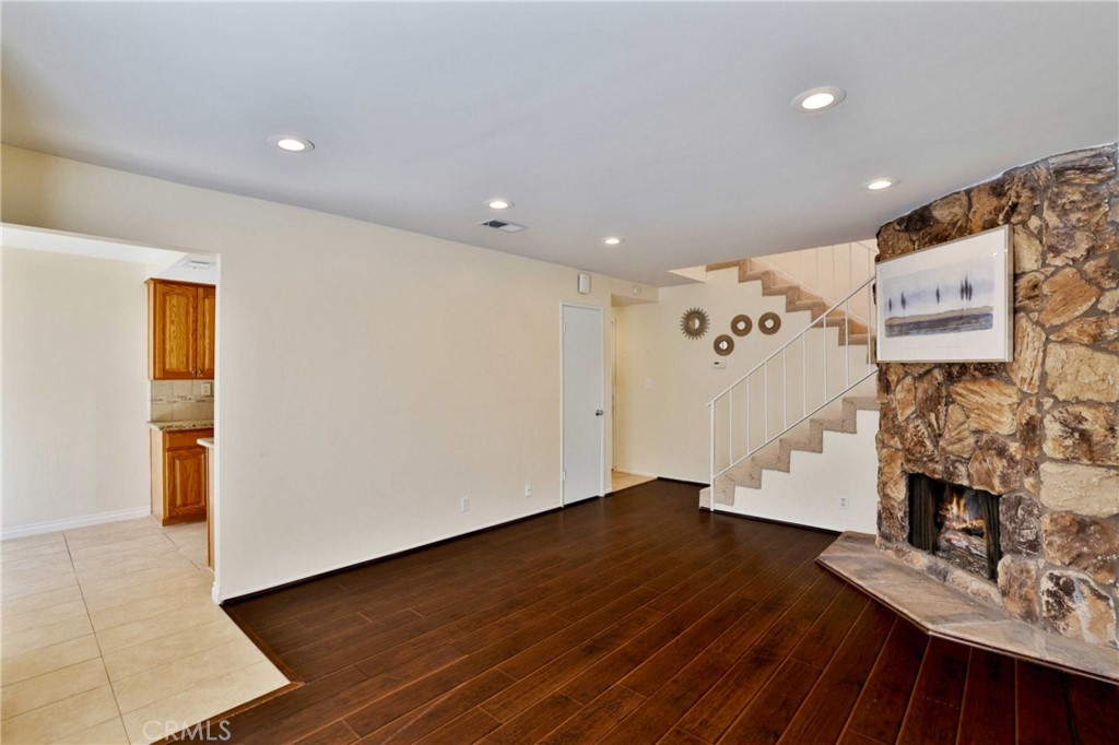 11557 Lower Azusa Road, Unit D El Monte, CA 91732 - Photo 7 of 38 a view of an empty room with wooden floor and a fireplace