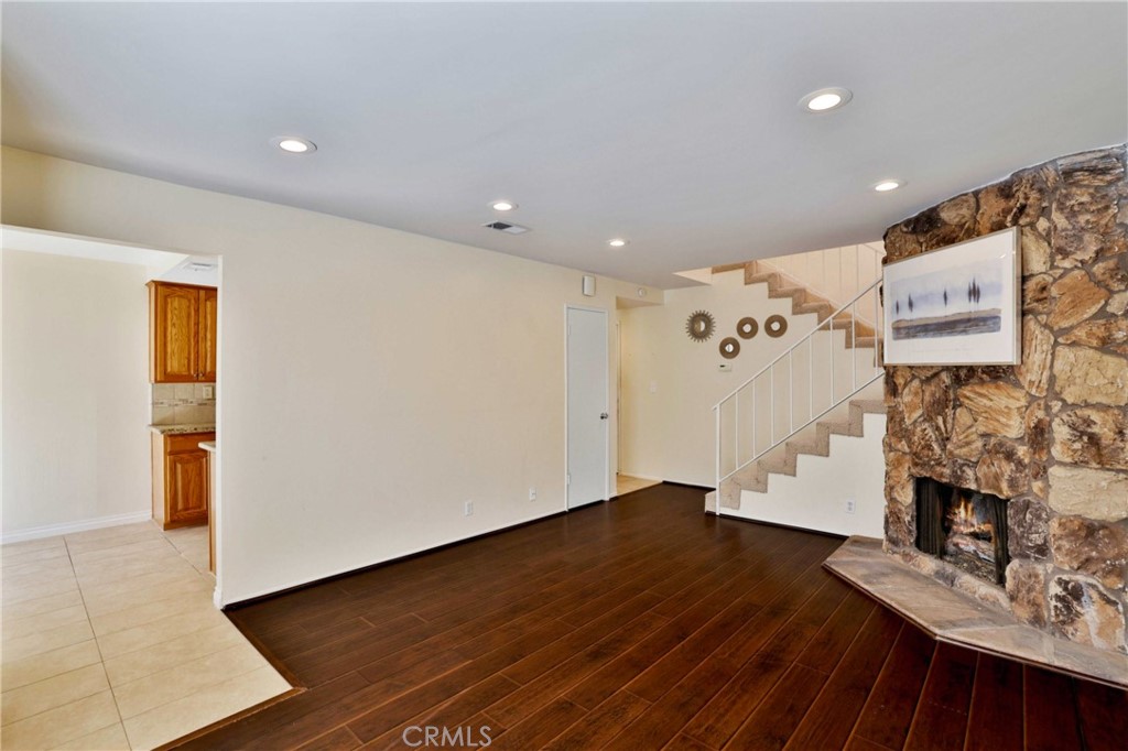 11557 Lower Azusa Road, Unit D El Monte, CA 91732 - Photo 9 of 38 a view of an empty room with wooden floor and a fireplace
